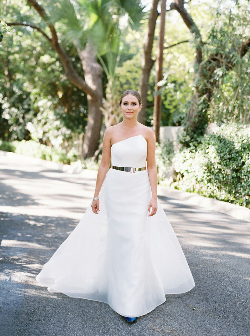 bride in strapless white wedding gown with silver belt