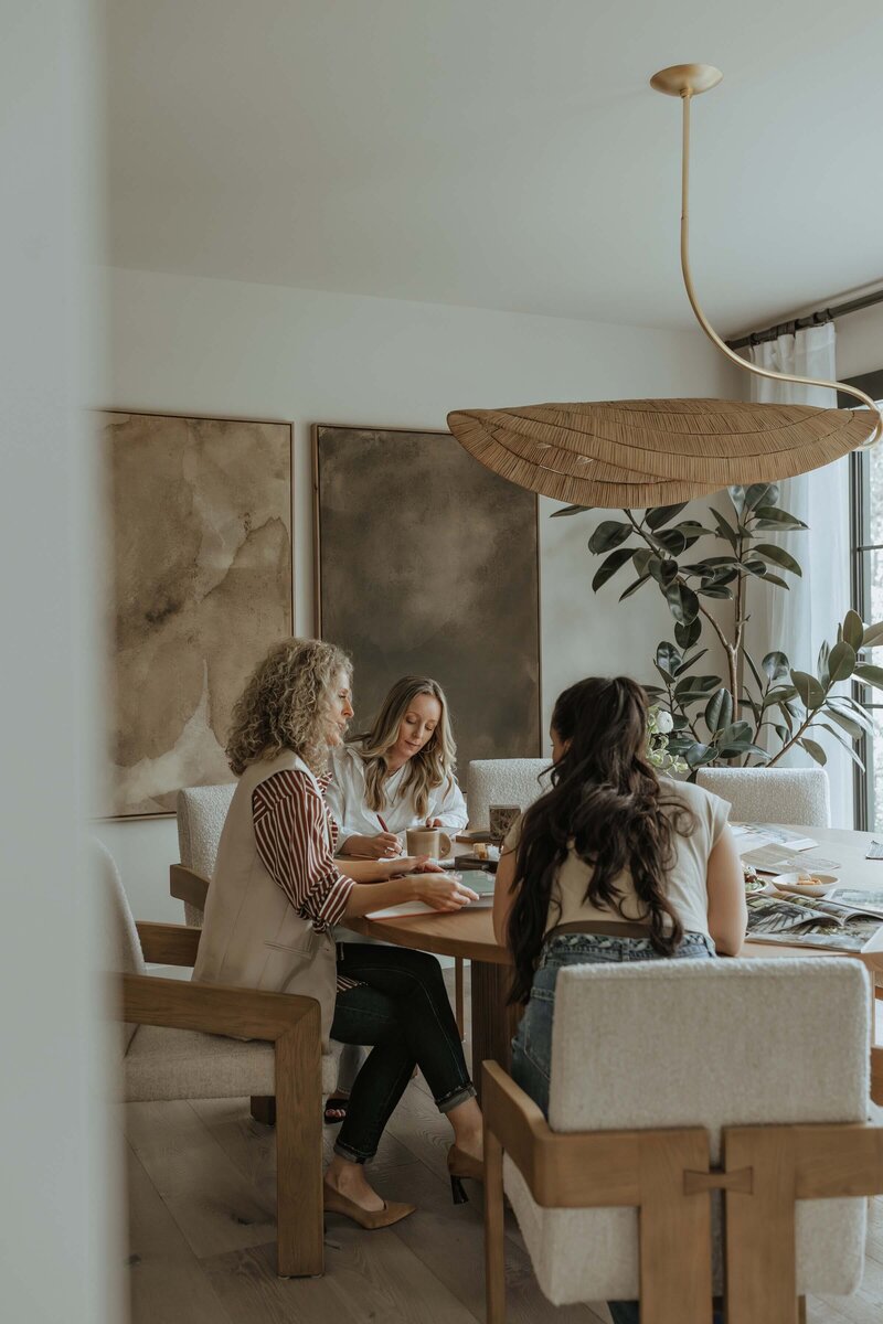 Creative team of interior designers brainstorming and collaborating in a modern studio setting.