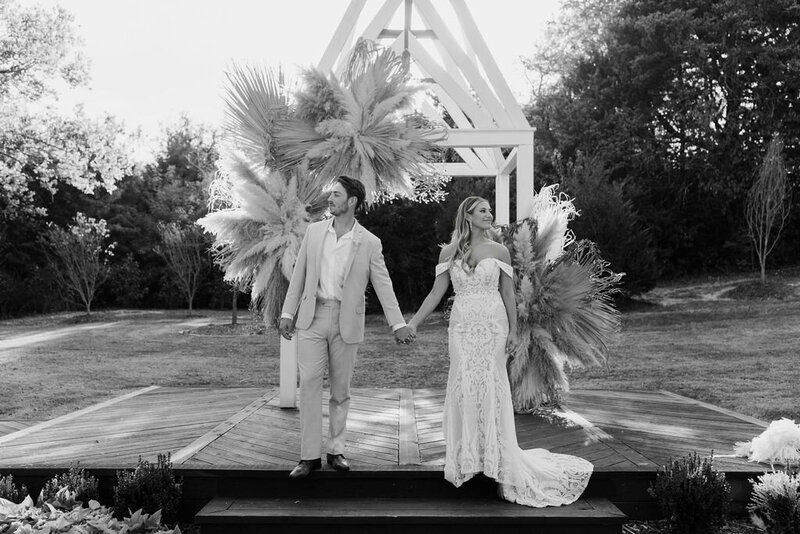 Bride and groom under chapel