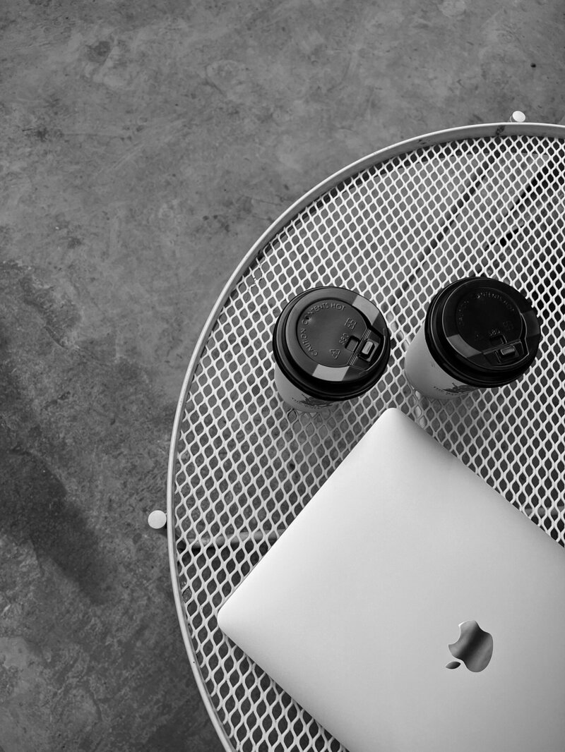 Image of two coffee's at a meeting about creative brand design