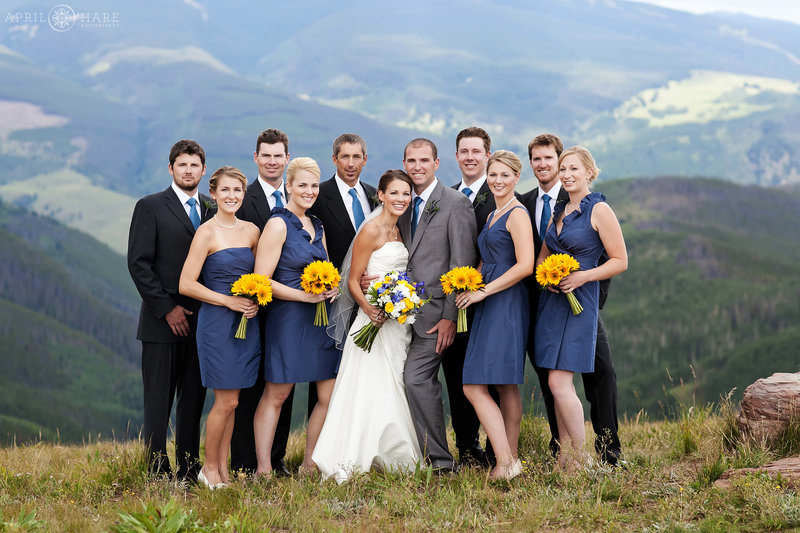 Classic wedding party portrait at Holy Cross Event Deck with mountain view backdrop on a stormy summer day in Colorado