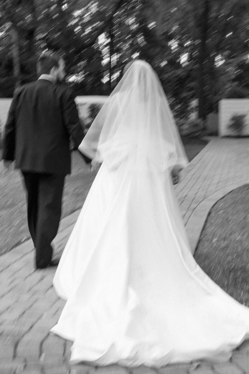 Bride and Groom Looking Back Over Shoulders Photo