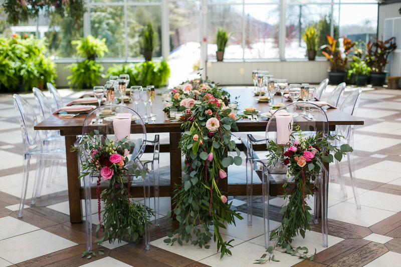 Real Raleigh wedding reception with farm tables and greenery garland