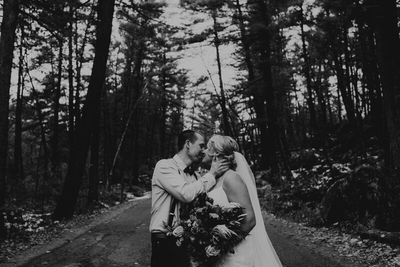 couple embracing on tree-covered road
