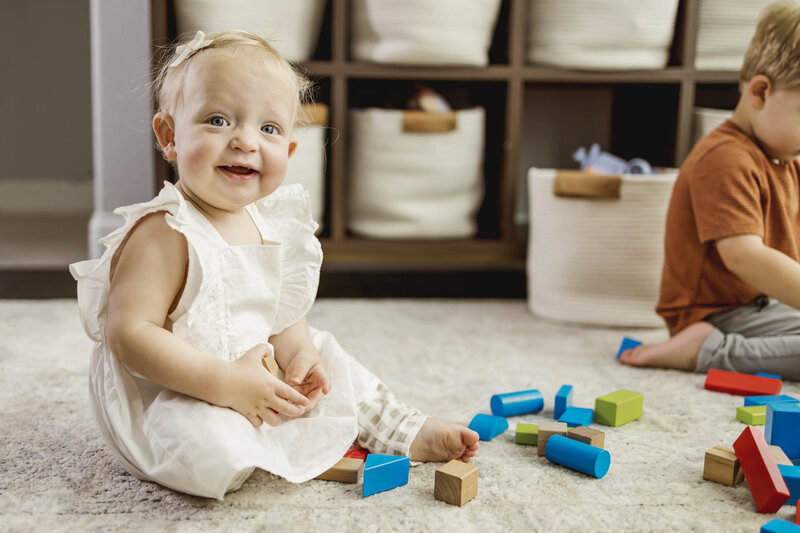 Little girl at her home in Carrollton, Texas plays with her blocks