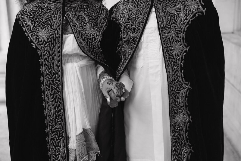 bride and groom holding hands for their luxury wedding portraits