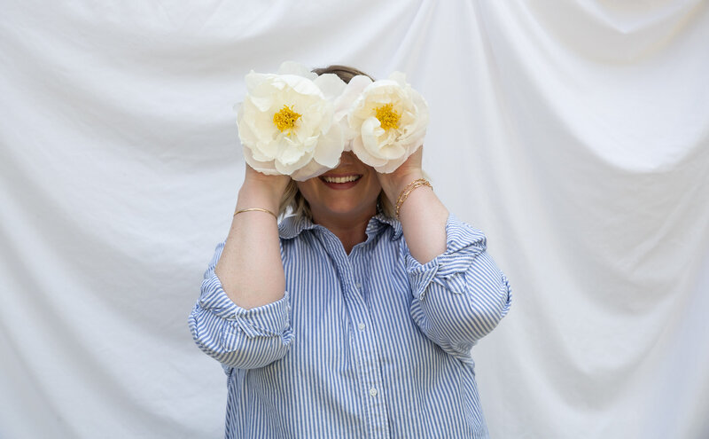 Graphic, web and branding designer Bess Brownlee smiles outside in Missoula, Montana.