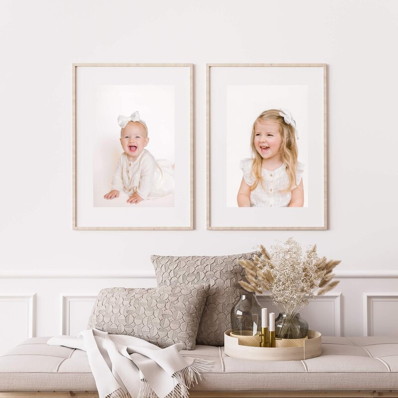 Beautiful framed portraits of two young sisters dressed in cream in a luxury home