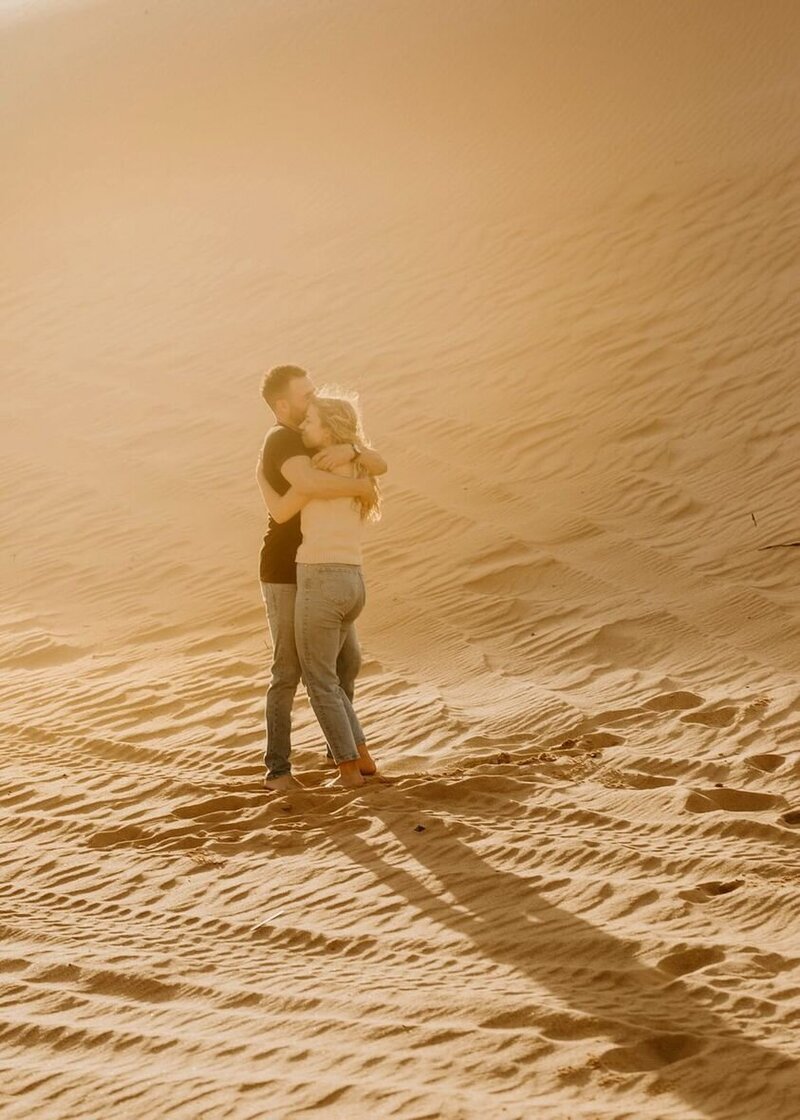 Adventure Couples Photography Session. Couple embrace in Little Sahara Park, Oklahoma