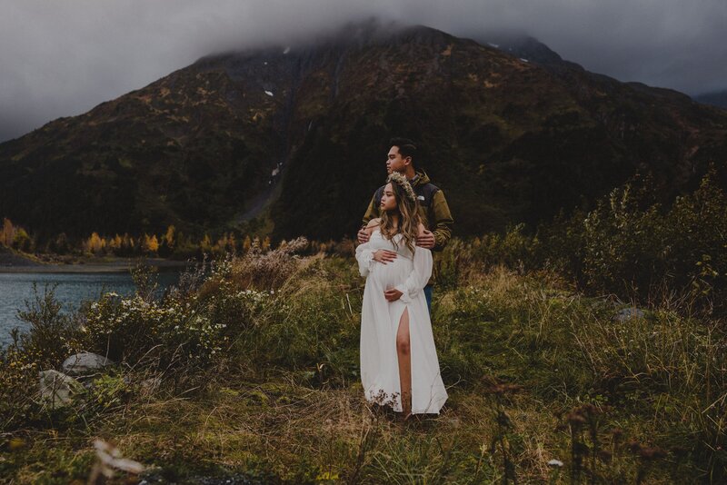 An couple poses in Portage Valley during their Moody Alaska Maternity session