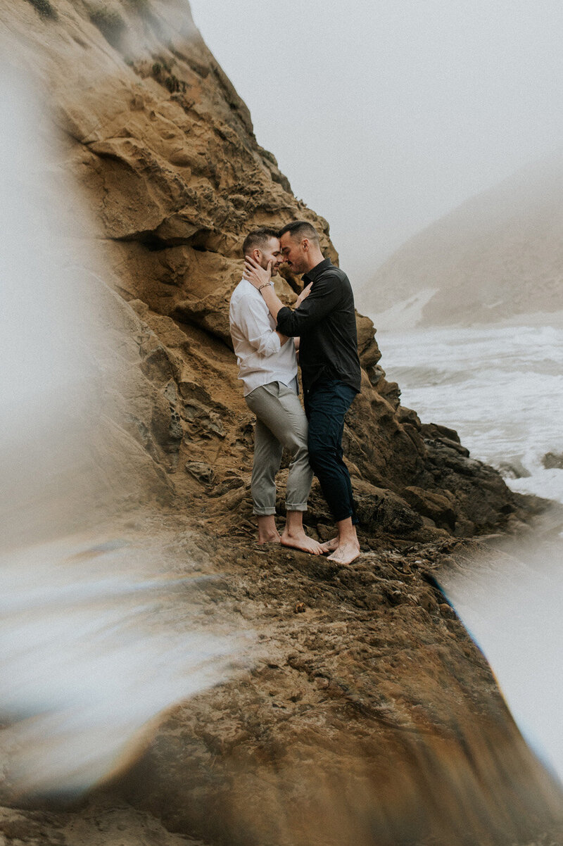 Elopement Photography, couple standing on cliffside next to the water