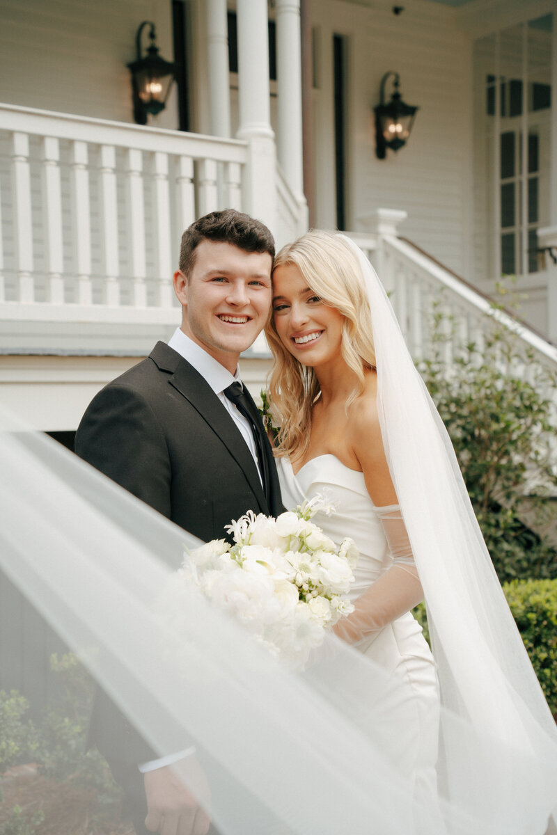 Bride and groom smiling together in a portrait at Admirals House wedding venue in Charleston.