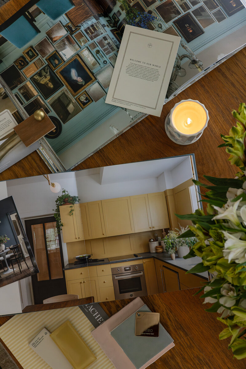 A detail image of a colorful sample and material moodboard on a styled coffee table