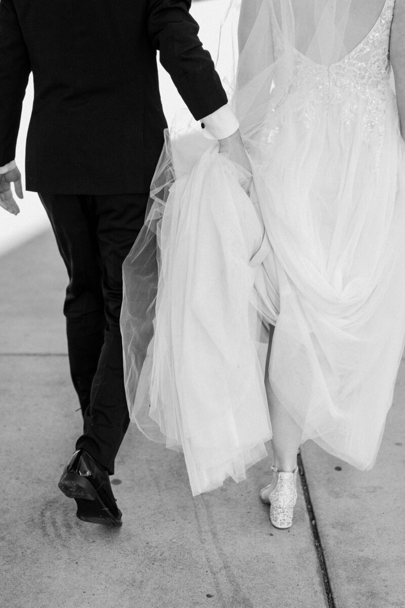 black and white image bride and groom walking