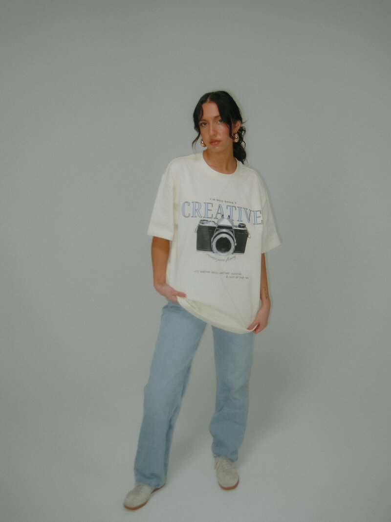 photographer posing with camera on her head