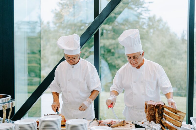Celso, of Crossed Keys estate staff, serves wedding guests from catering line