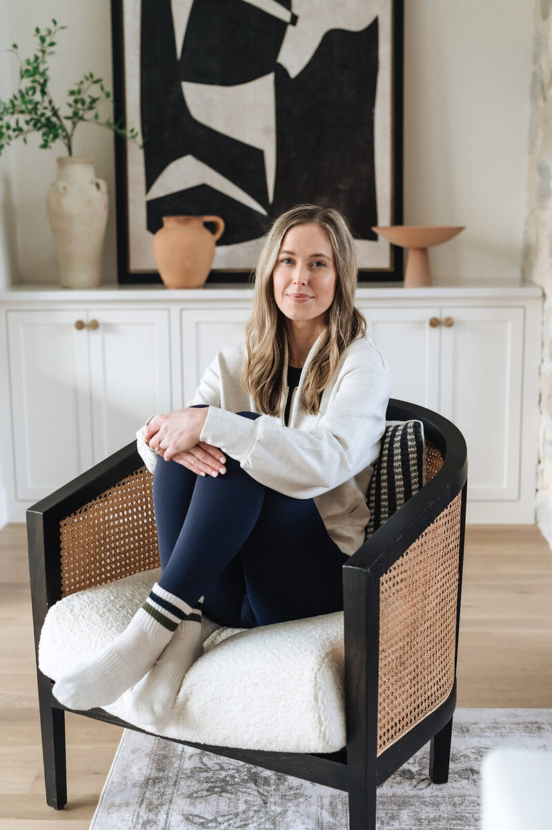 Erica Taylor sitting reflectively, sharing her story of burnout, motherhood, and finding balance through small wellness shifts