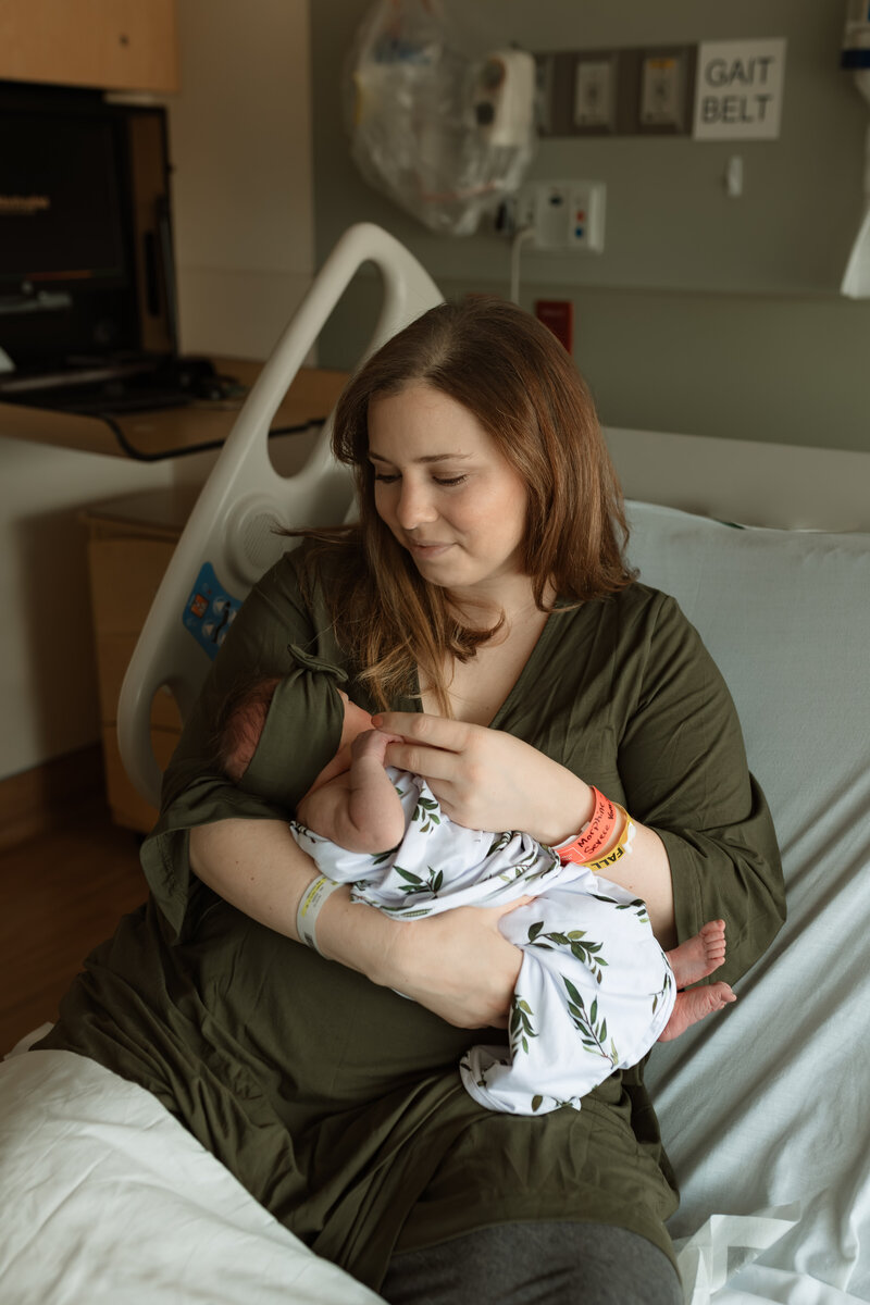 Mom holding a newborn in her arms at a fresh 48 session in the hospital