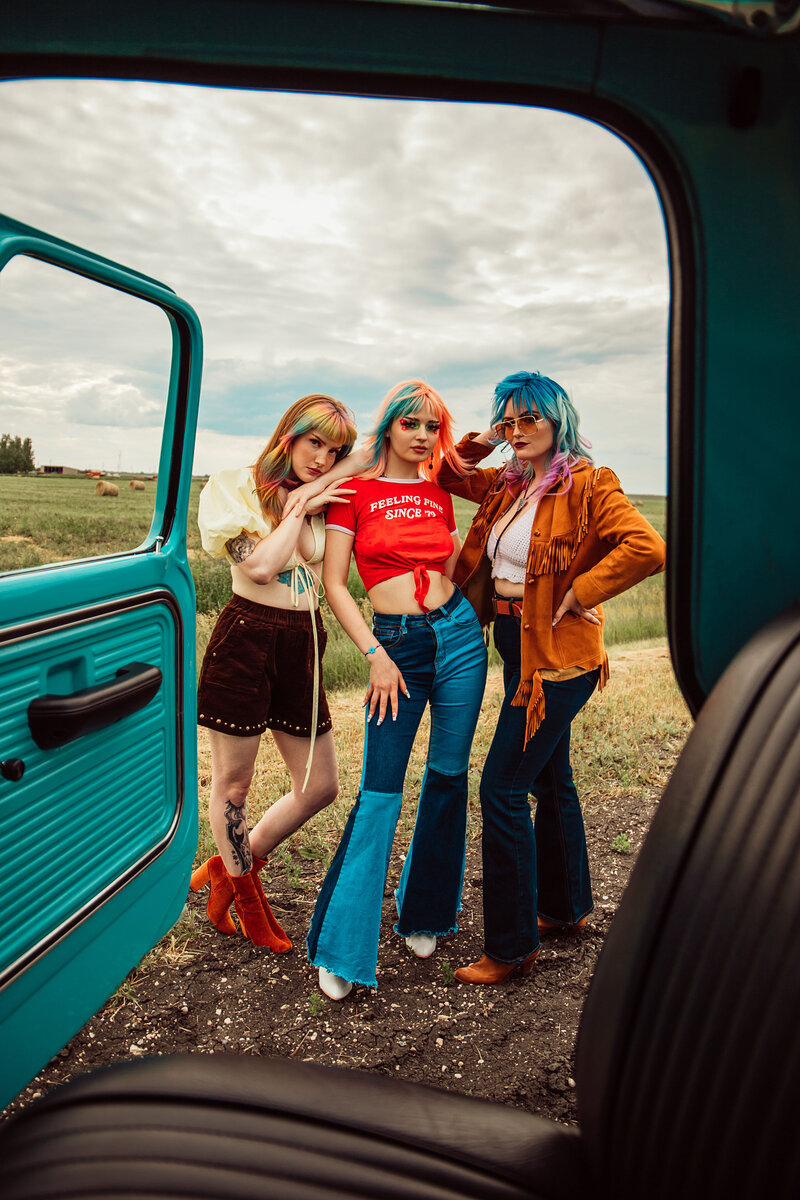 close up of woman in truck with multi-colored hair