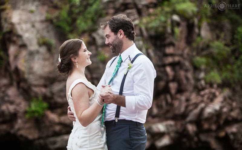 Bride and Groom first dance with pretty rock cliff backdrop at Riverbend in Lyons Colorado