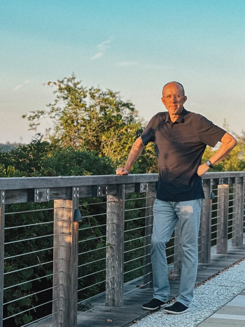Erich Fogg, PA-C and exam prep coach to PA students and programs standing on deck at home