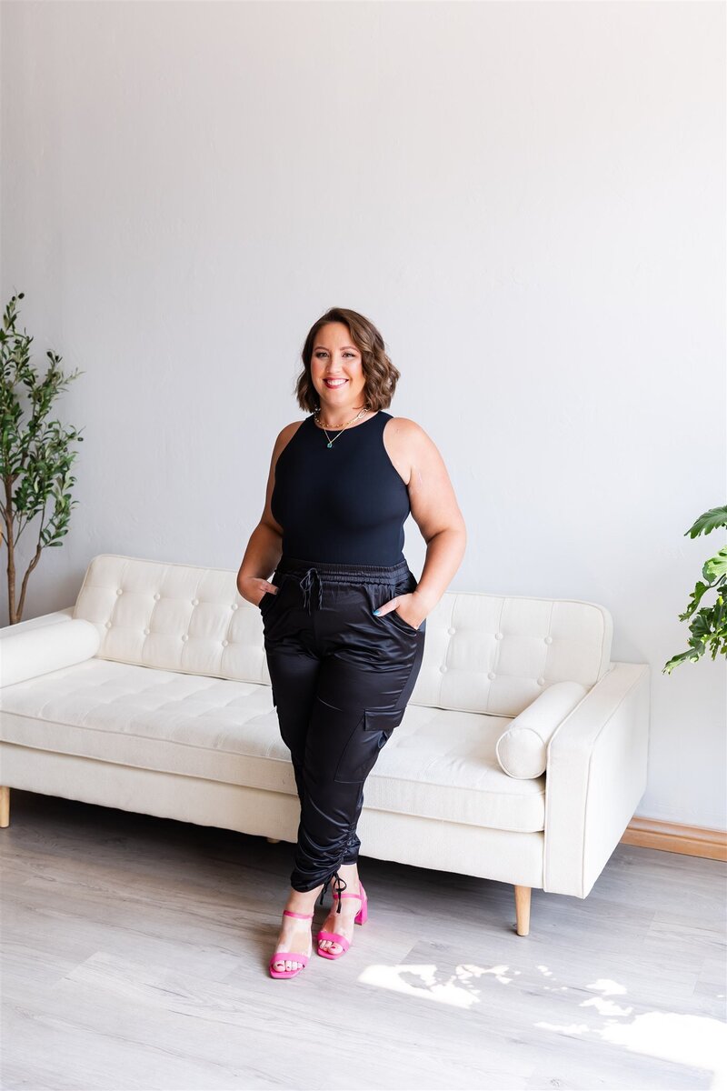 Life coach, Kathryn Konicek, smiling with her hands in her pockets