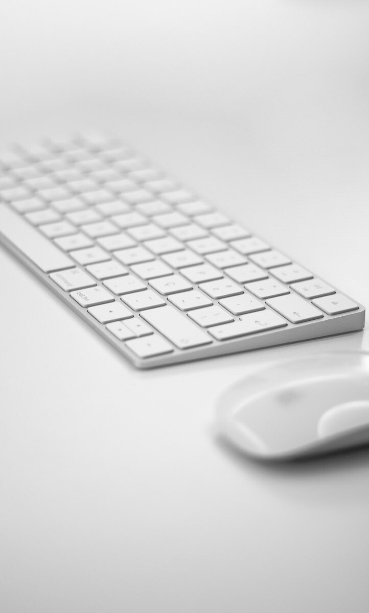 white keyboard and white mouse on white desk