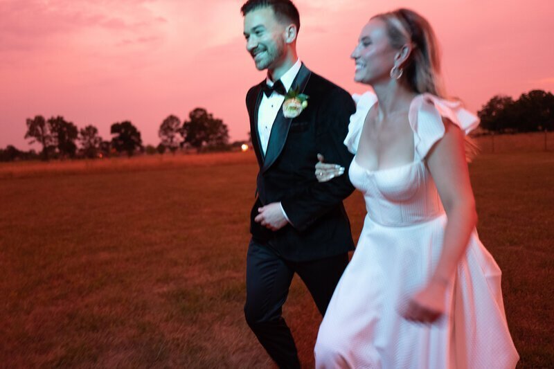Bride and groom walking in sunset by best film wedding photographers Noble Photo Co