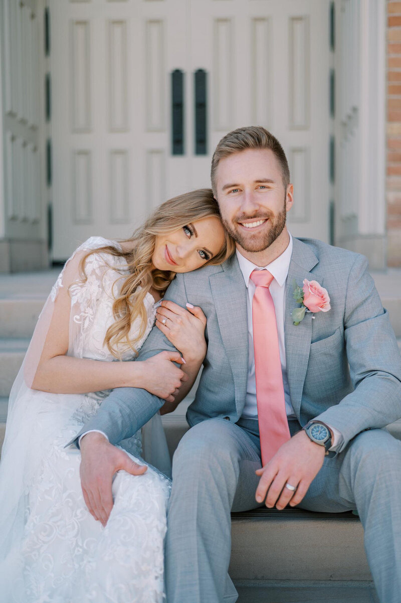 bride and groom sitting on church steps