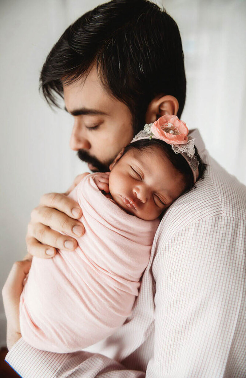 Father embraces his daughter during their family portrait session on the Blue Ridge Parkway in Asheville, NC.