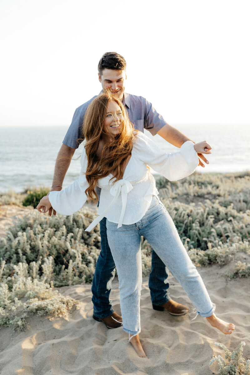 Wedding and Elopement Photographer, woman fanning herself in robe standing in a doorway