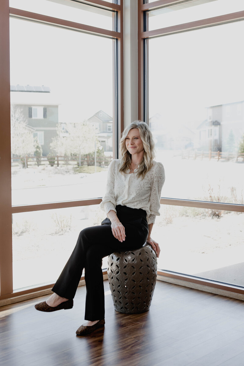 Kristin sitting peacefully by a window, ready to help buyers take the next step toward homeownership with clarity and care.