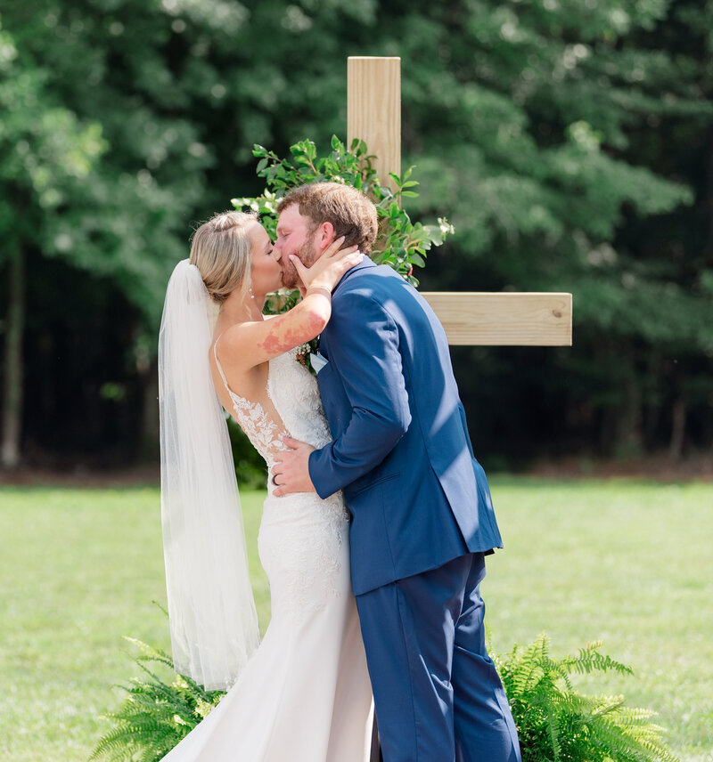 First kiss of the bride and groom during  a timeless ceremony.