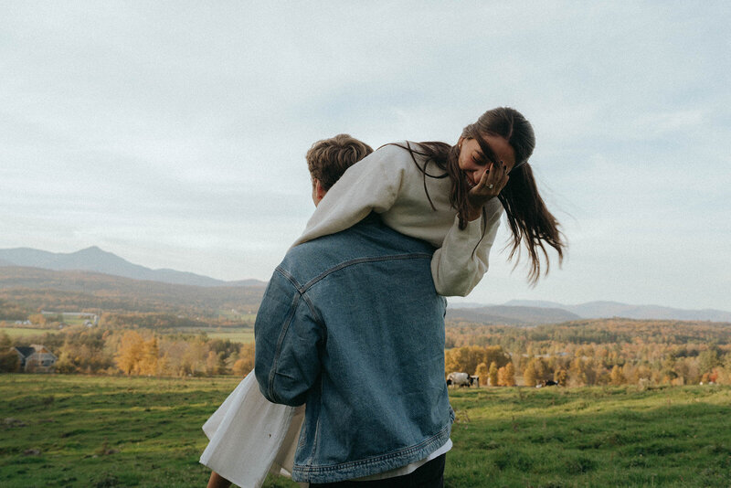boy holding a girl over his shoulder for vermont engagement photos, wedding photography prices
