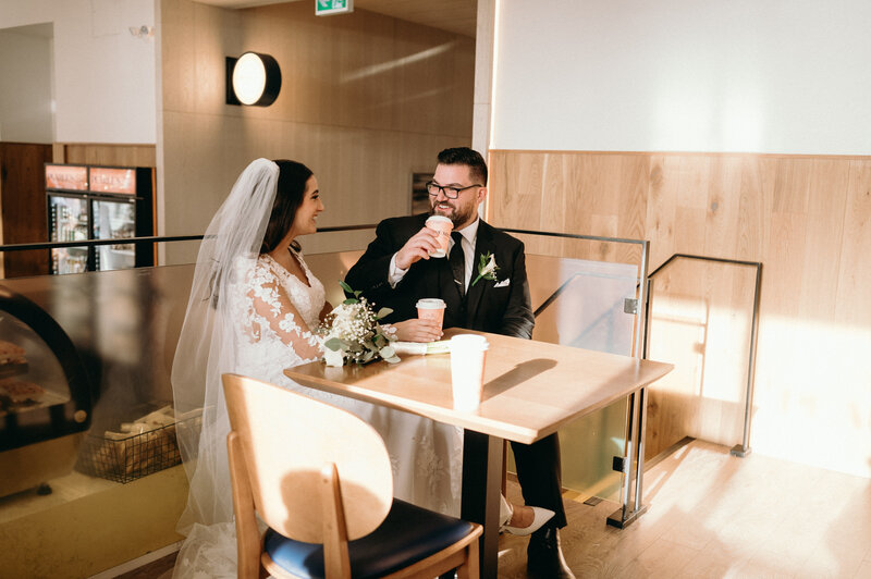 two brides smiling holding hands at Ontario wedding