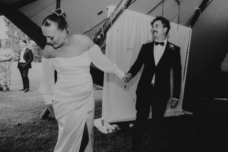 Newlywed couple entering reception of their wedding