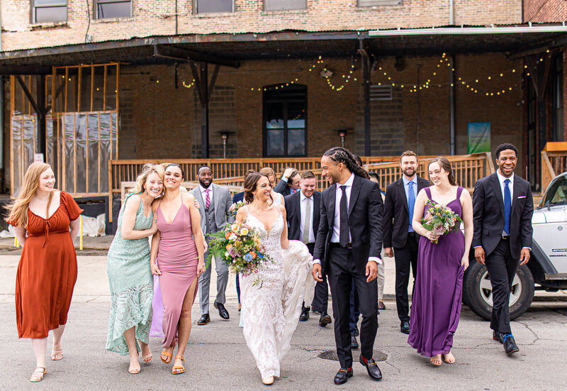 A couple and their wedding party walk outside of Lacuna Lofts in Chicago