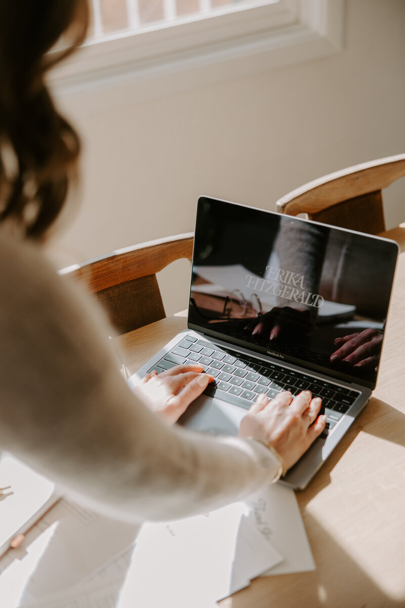 SEO website copywriter Erika Fitzgerald holding MacBook