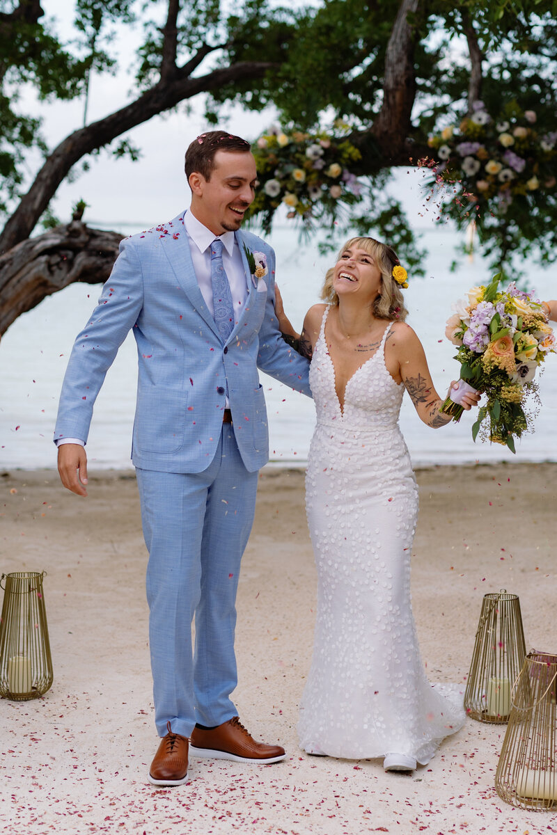 Bride and groom kissing on a pier