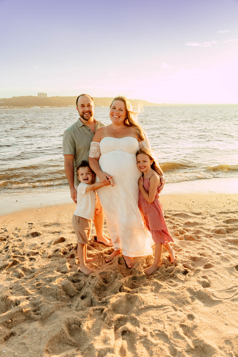 A family posing for a photo at Sandy Hook Beach in New Jersey