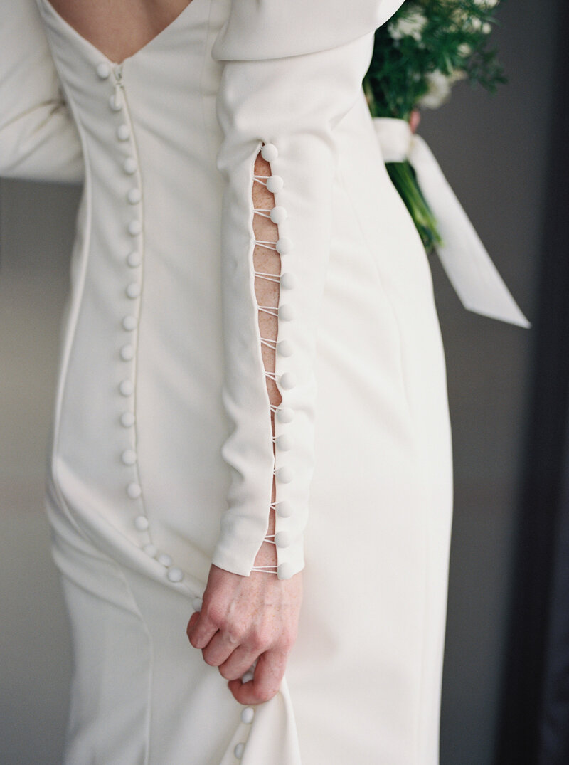 Elegant bridal gown detail photographed in soft natural light with fine art approach