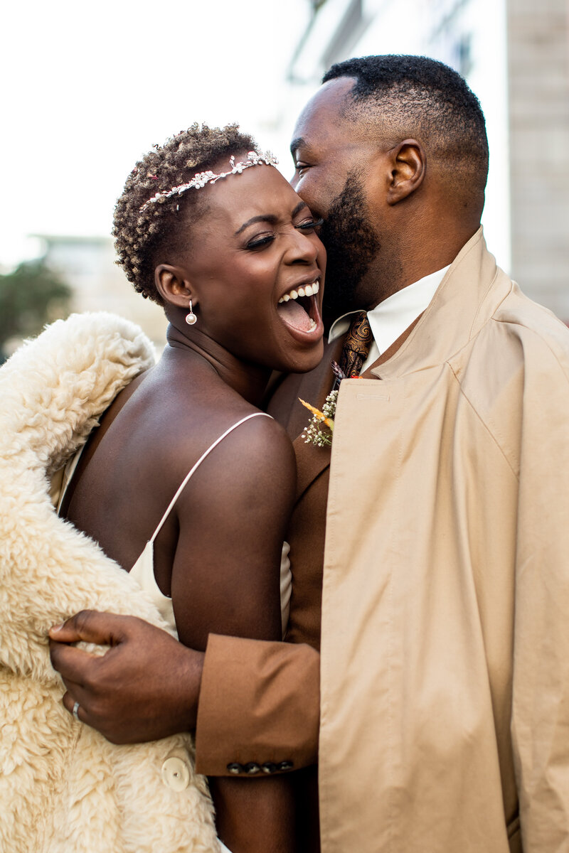 Black bride and groom laughing