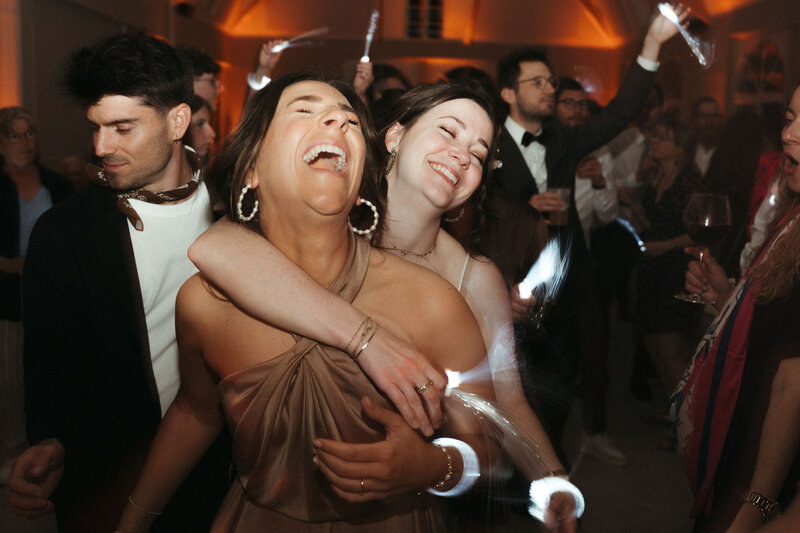 Deux amies enlacées en train de danser à un bal. Mariage au domaine des Longrais en Bretagne par Kamescop. 