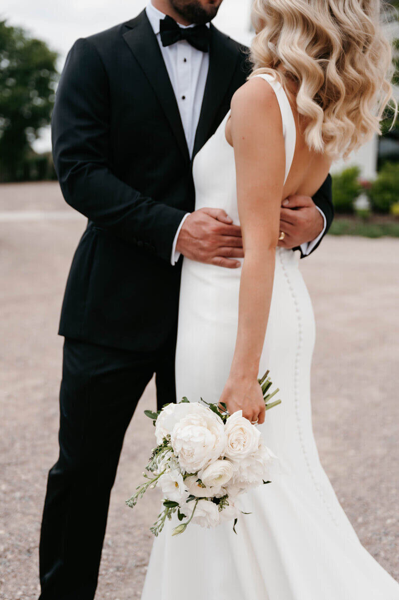 Bride and groom embracing by luxury wedding planner chicago