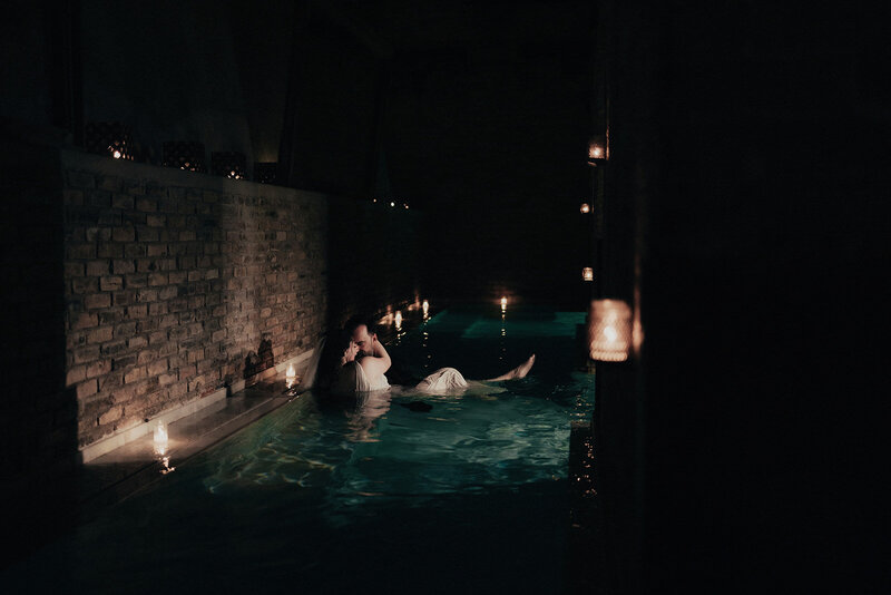 Historic first-ever wedding at any AIRE Ancient Baths location, featuring bride and groom in steamy candlelit pool in Chicago, captured by Bradi Potter