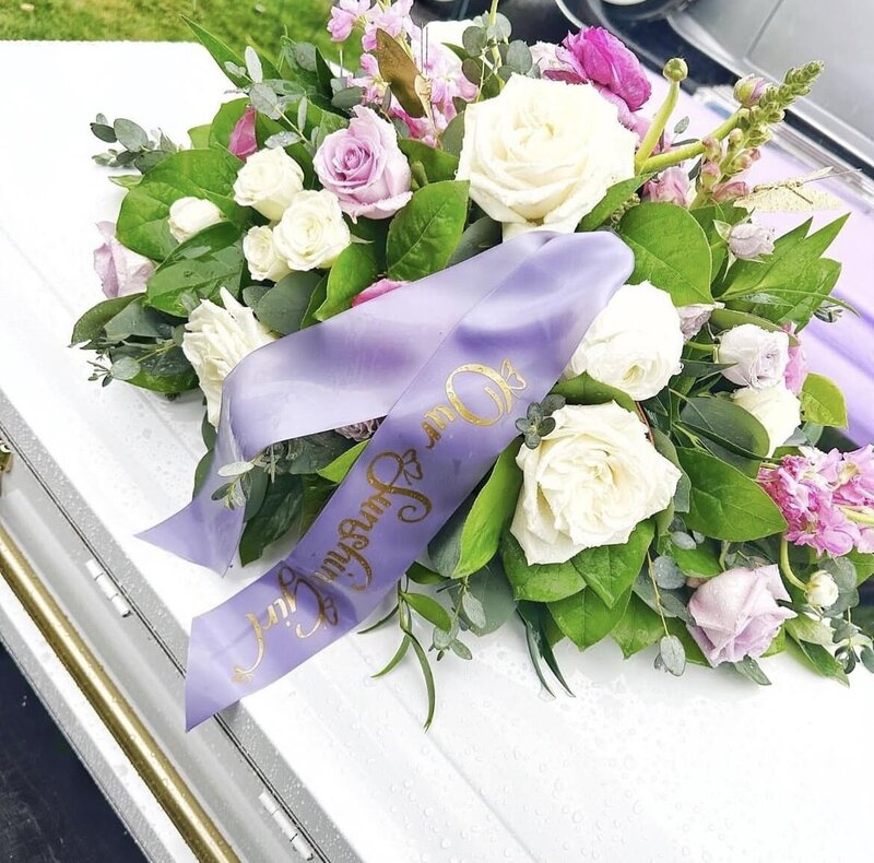 beautiful bouquet at her feet of the bride and grooms feet
