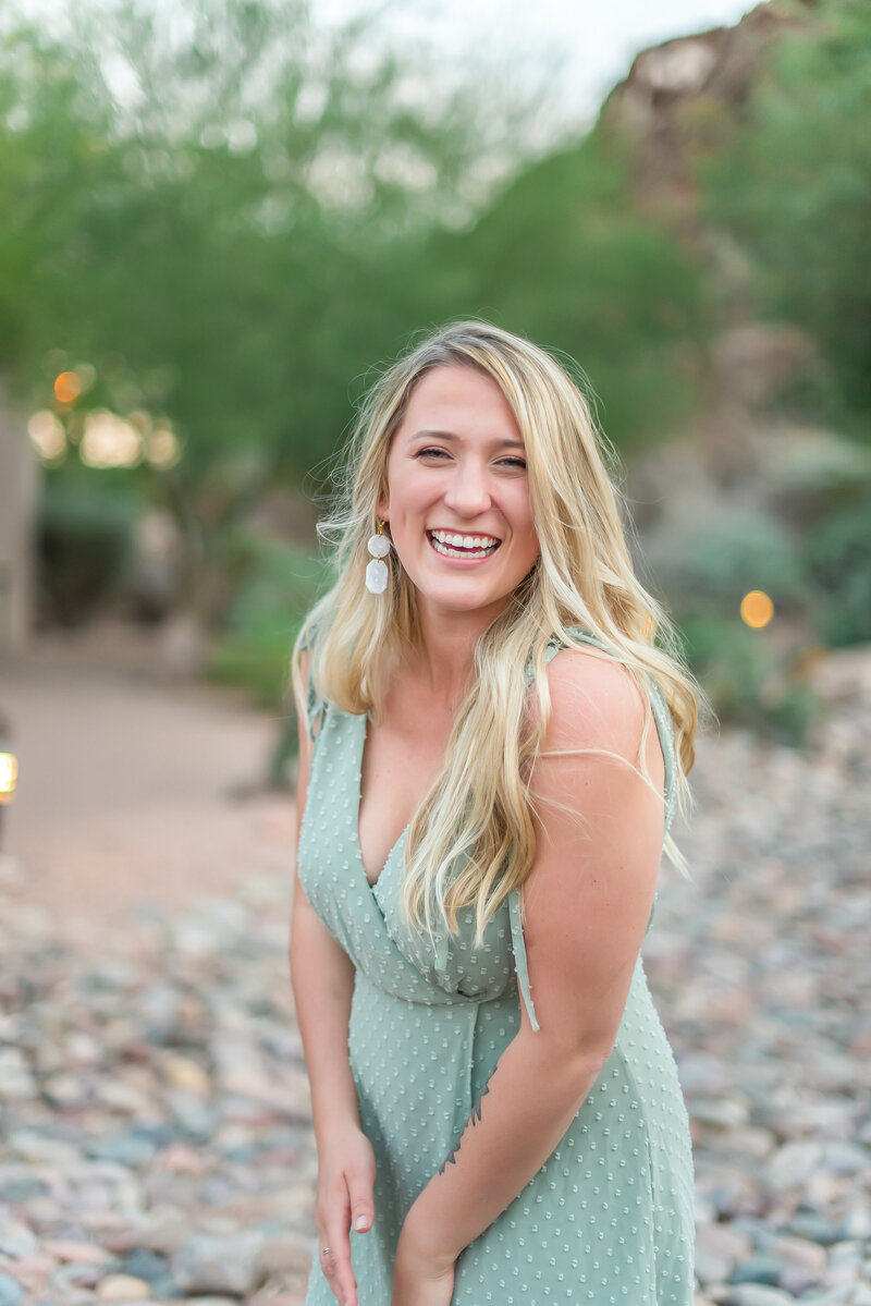 Paige Kuffel laughs and smiles at camera, owner of Kuffel Photography in Madison WI