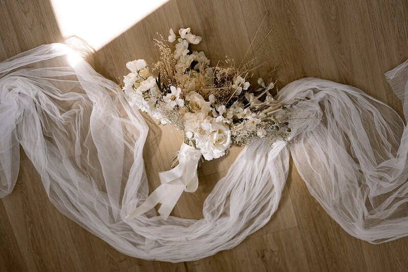 flowers at a wedding on a wooden floor.