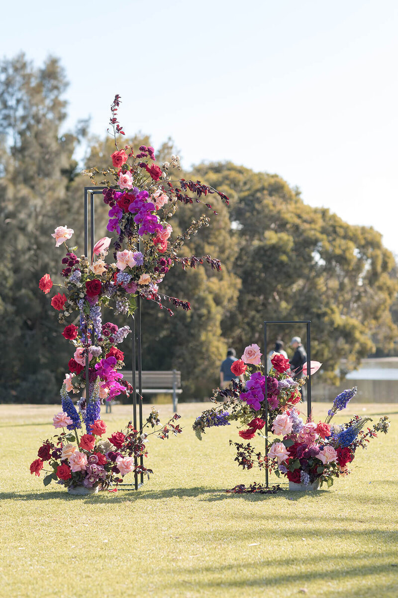 wedding-ceremony-pink-red-purple-floral-installation
