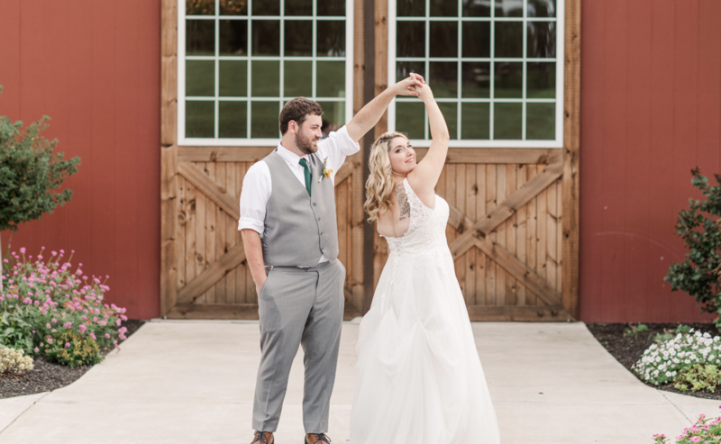 couple dancing in front of barn doors during their wedding by york and lancaster pa photographer